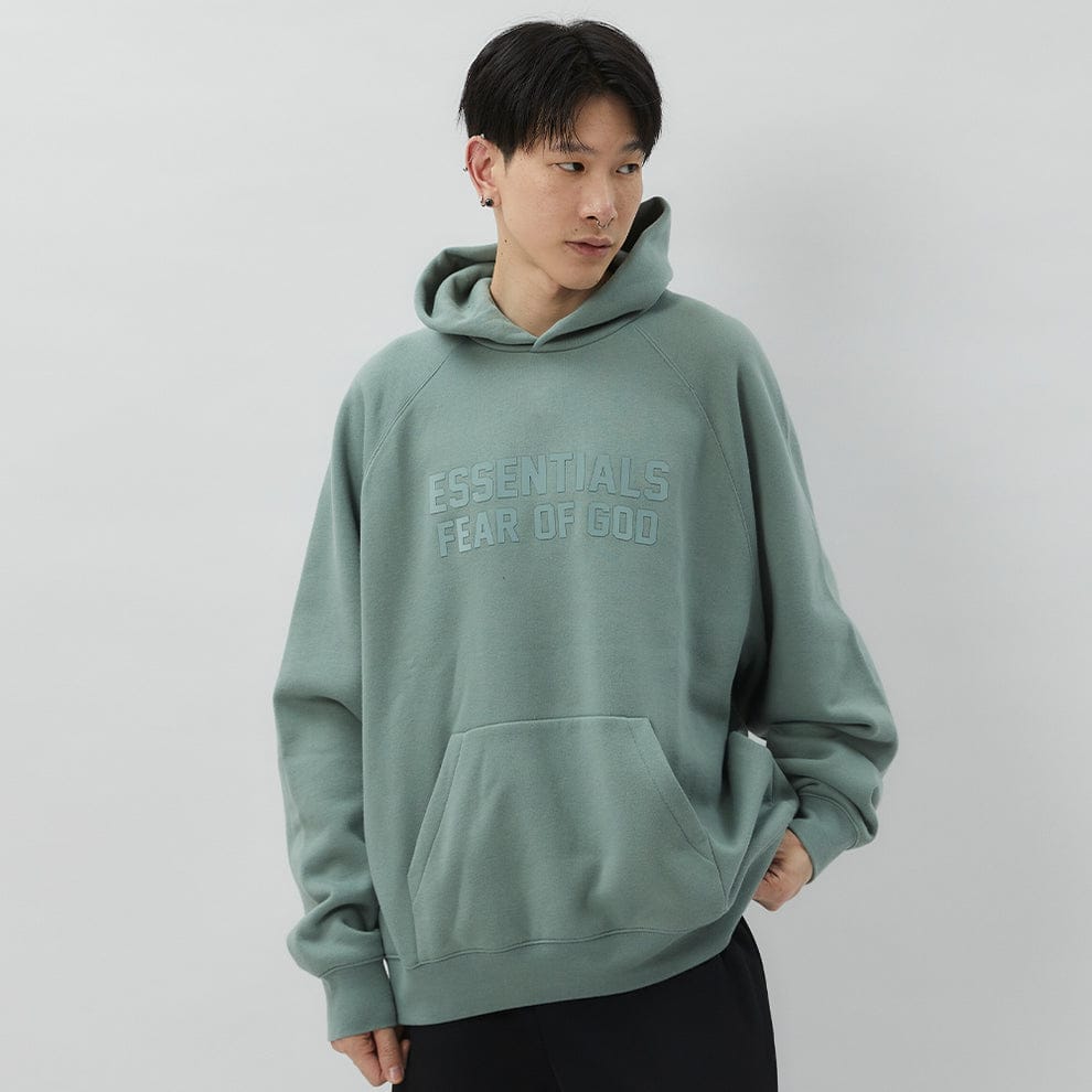 Essentials Fear of God Essentials hoodie in Sycamore color, featuring a relaxed fit and soft fabric, displayed on a hanger.