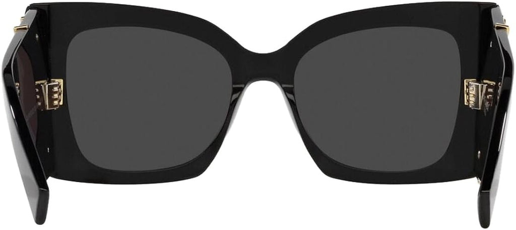 Black oversized sunglasses with dark gray lenses and gold-tone decorative hardware on the temples, shown against a plain white background.