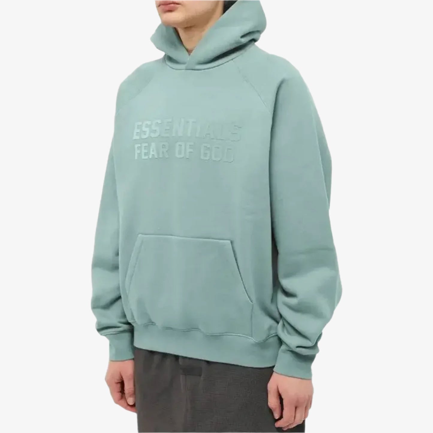 Fear of God Essentials hoodie in Sycamore color, featuring a relaxed fit and logo design, displayed on a hanger.
