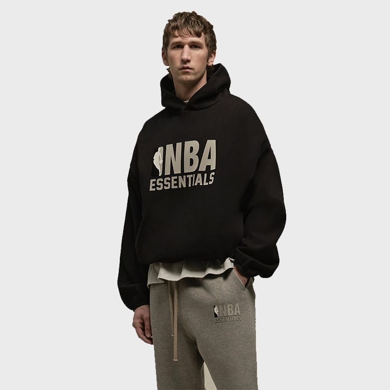 Black Fear of God Essentials x NBA hoodie featuring a bold logo design and comfortable fit, from THE EA STORE.