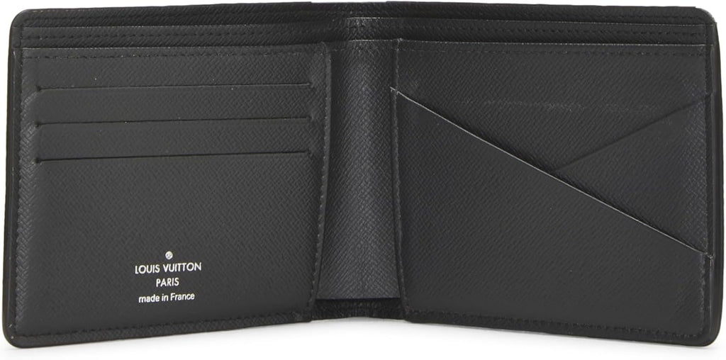 Black Louis Vuitton wallet open on a white background