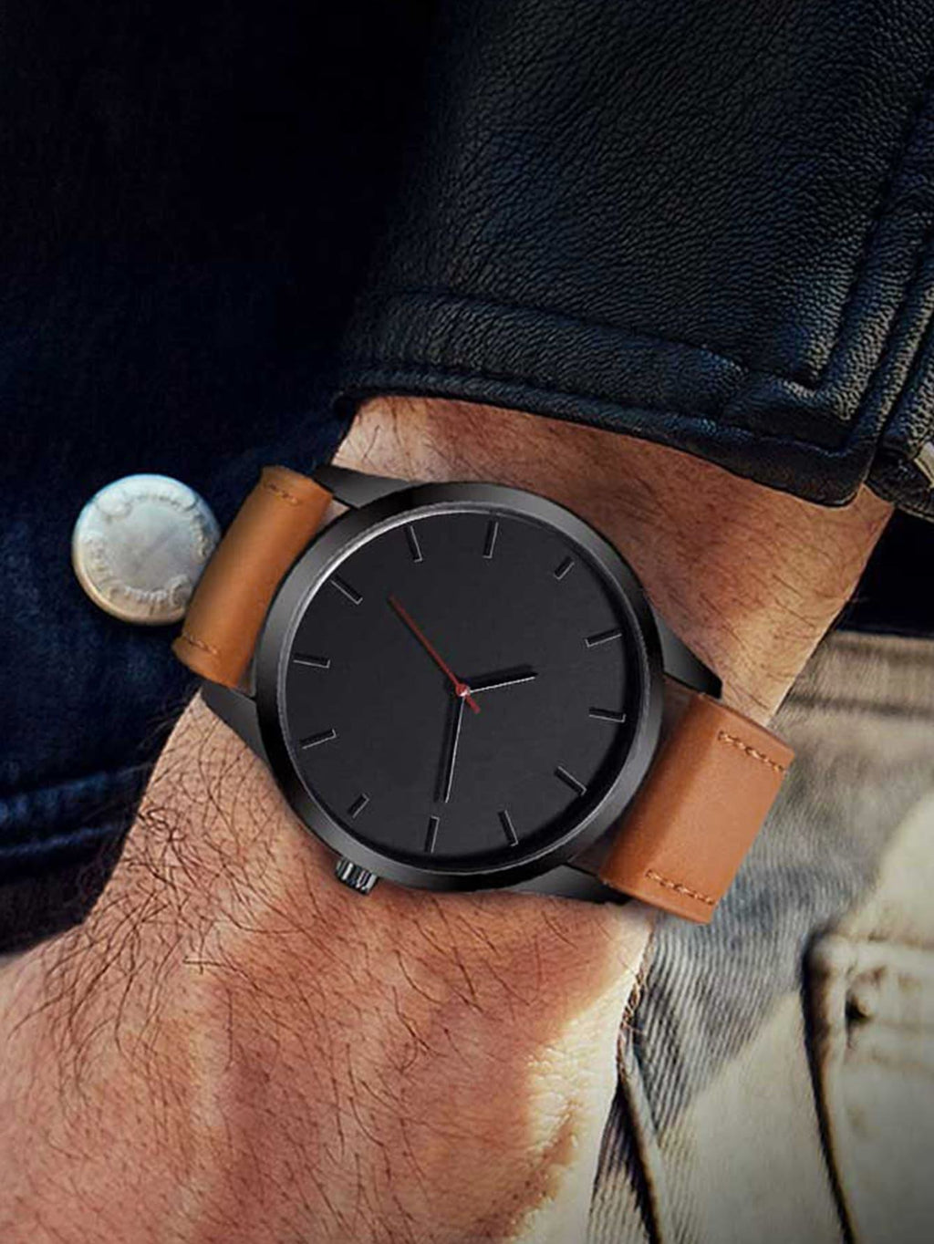 Black watch with brown leather strap on a wrist