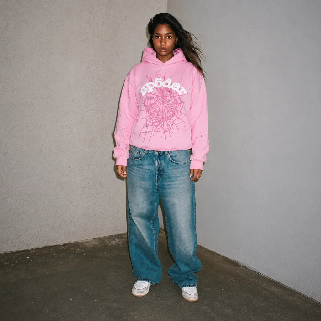 Pink Sp5der Web Hoodie by THE EA STORE, featuring a bold web design, long sleeves, and a casual streetwear style.