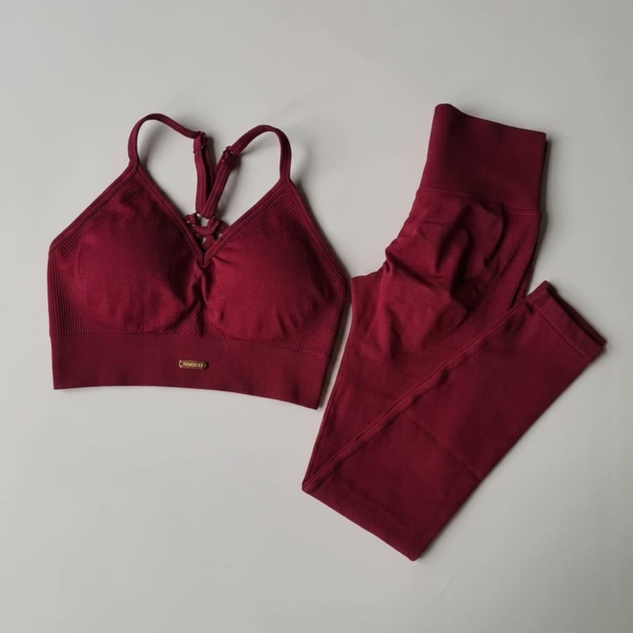 Maroon sports bra and leggings set on a light gray background