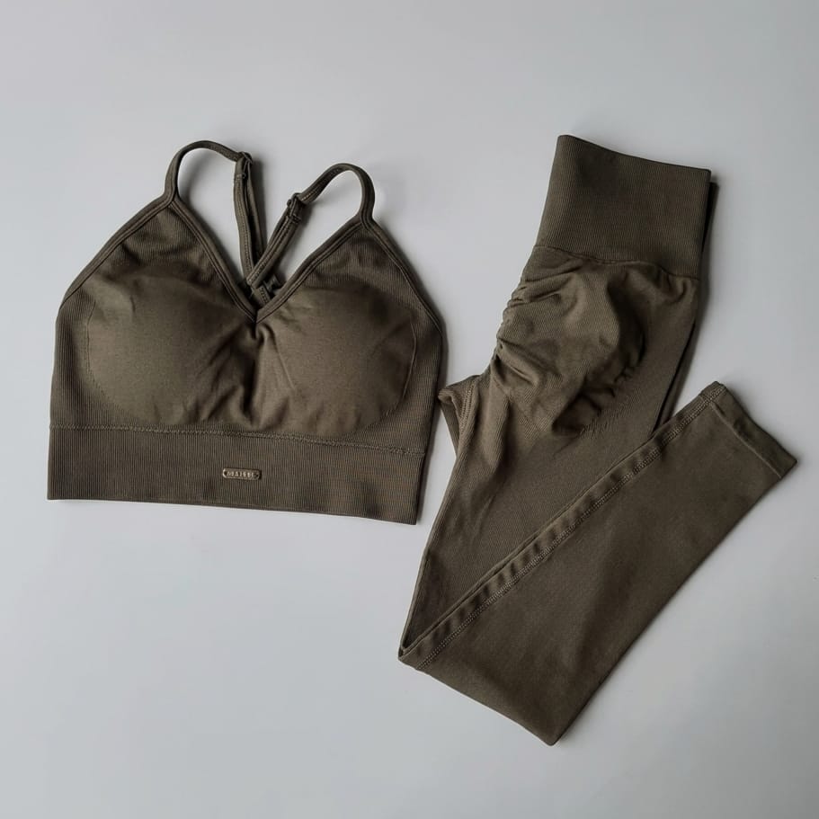 Olive green sports bra and leggings set on a light gray background
