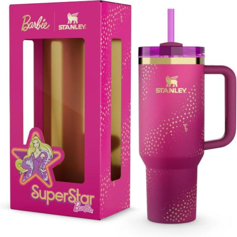 Pink Stanley tumbler with handle and straw lid, featuring Barbie SuperStar design, next to its packaging.