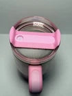 Pink water bottle with straw lid on a white background
