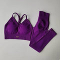 Purple sports bra and leggings set on a gray background