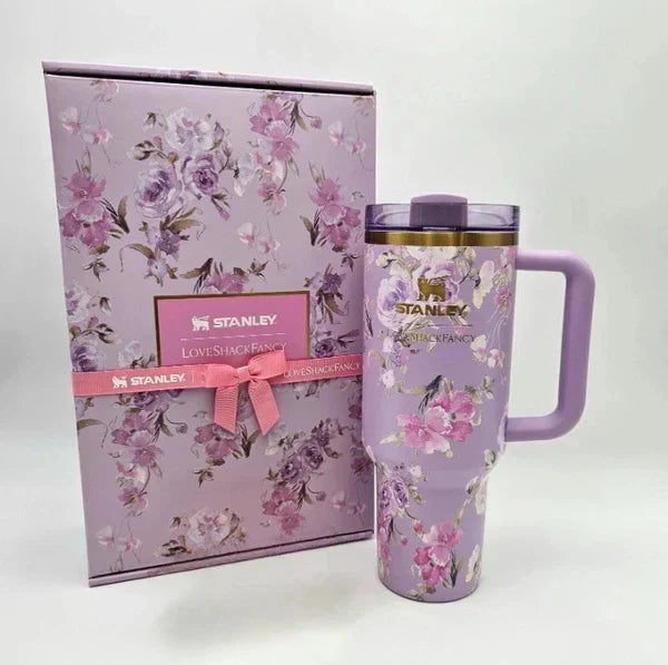 Floral-patterned Stanley mug and packaging on a white background