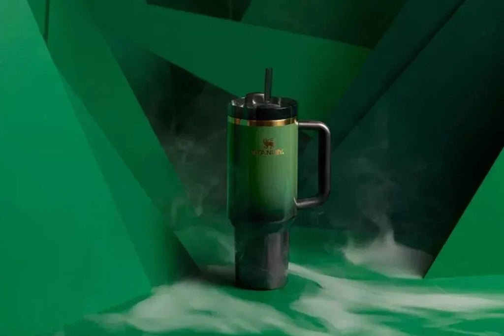 Green mug with gold accents on a green background