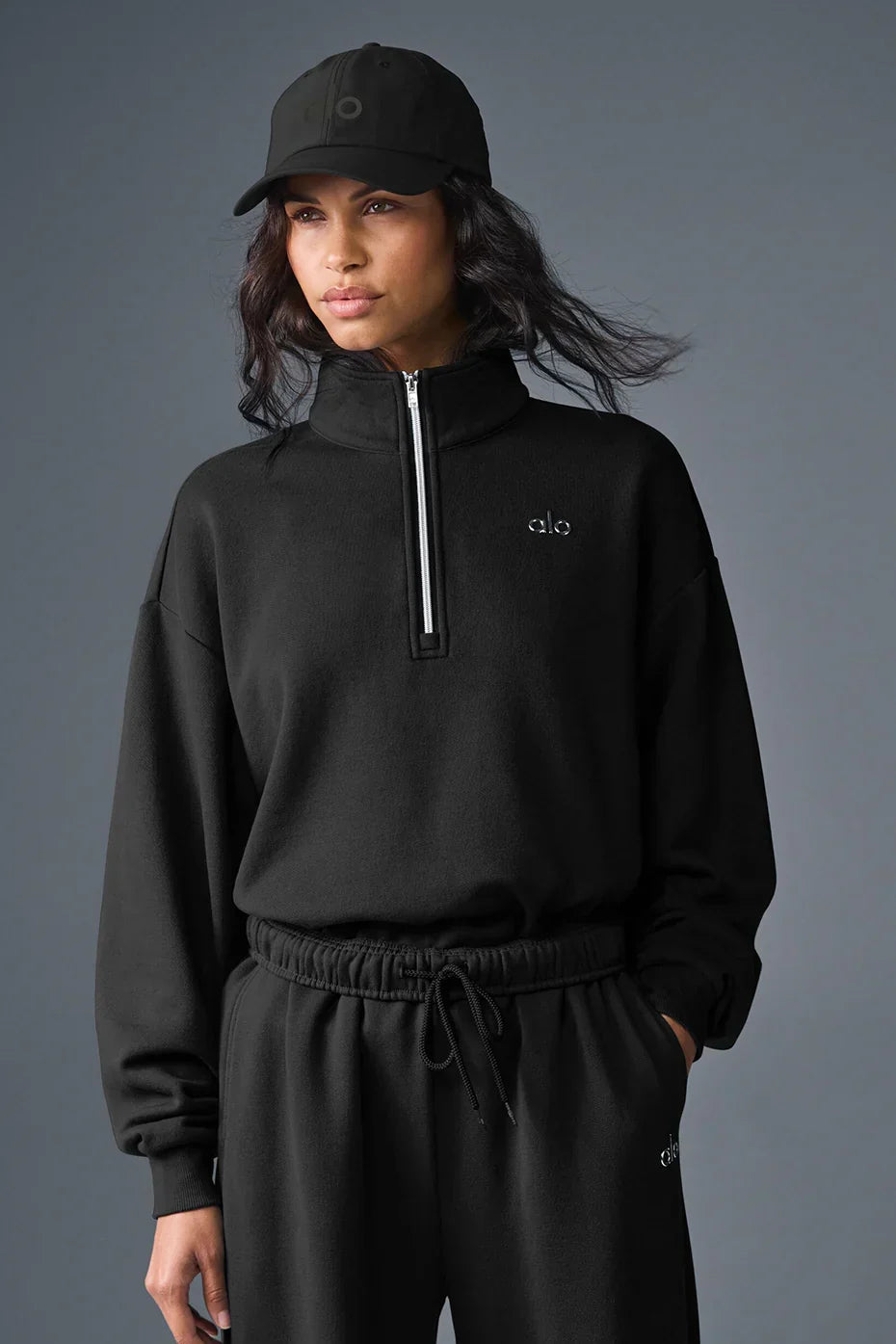 Alo Yoga Unisex Accolade Half-Zip Sweatshirt in gray with a high collar and half-zip front, casual athletic style.