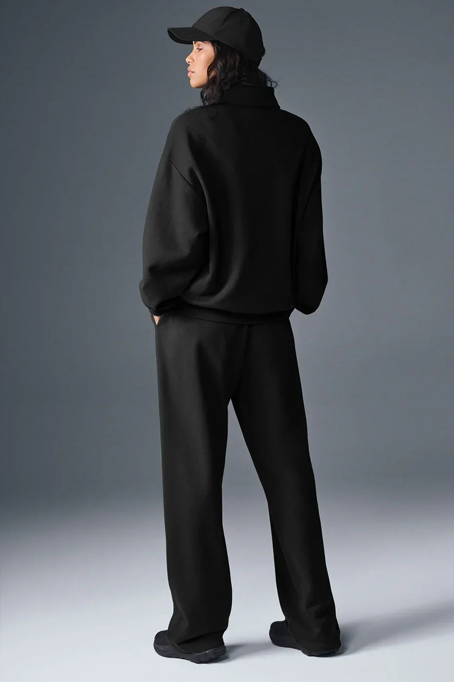 Alo Yoga Unisex Accolade half-zip sweatshirt in gray with ribbed cuffs and collar, displayed on a hanger.