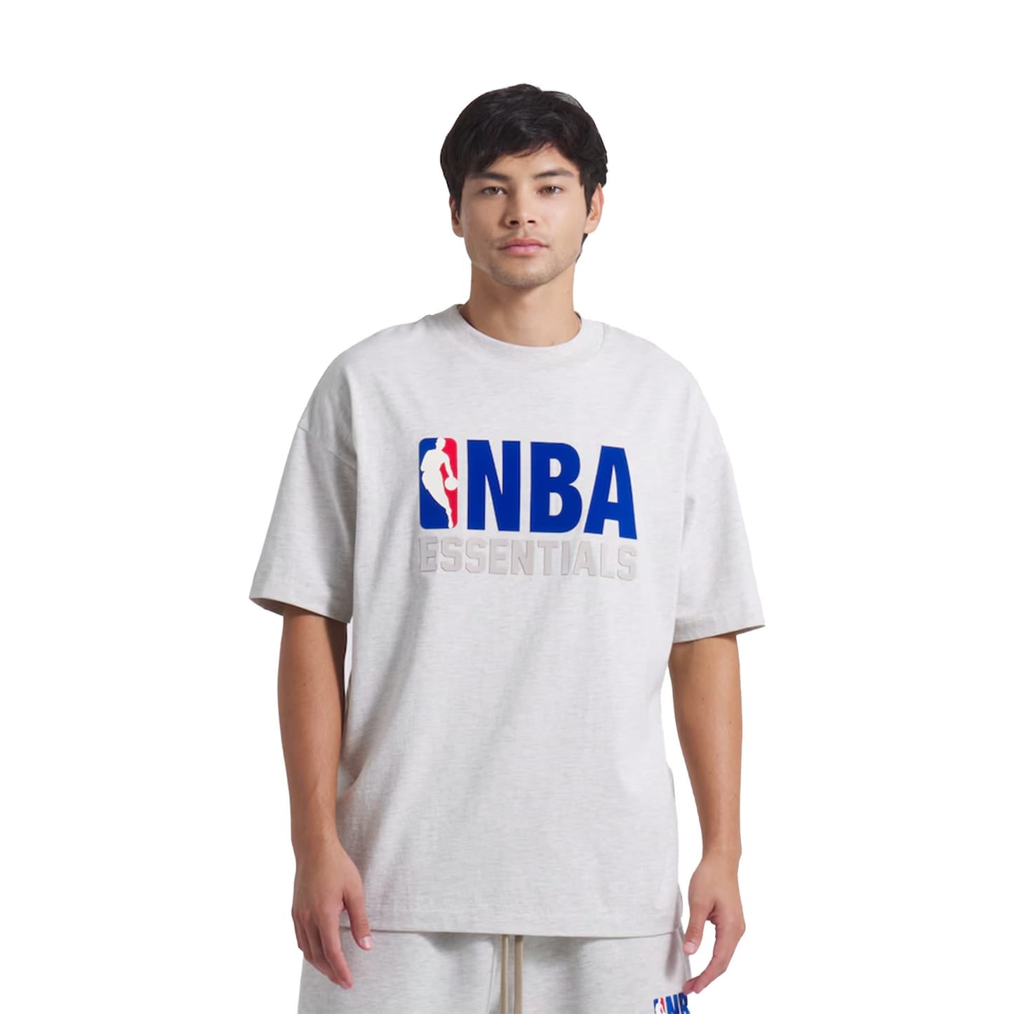 Light heather grey Fear of God Essentials x NBA T-shirt by THE EA STORE, featuring NBA logo and casual fit.