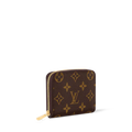 Louis Vuitton Monogram Zippy Coin Purse M60067 showing side view of compact leather wallet with gold zipper and monogram pattern.