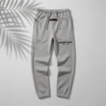 Dark oatmeal Fear of God Essentials relaxed sweatpants from THE EA STORE with a soft, comfortable fit and elastic waistband.