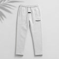 Light oatmeal Fear of God Essentials relaxed sweatpants from THE EA STORE, showing the comfortable fit and soft fabric.