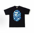 Black and blue BAPE ABC Camo Ape Head Tee from THE EA STORE, featuring the iconic ape face graphic on a casual essentials t-shirt.