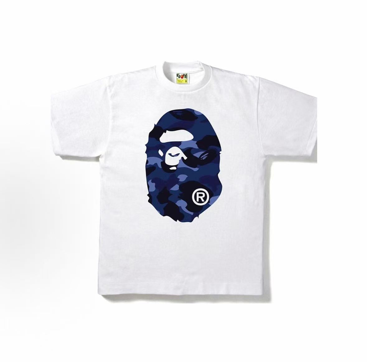 White and blue BAPE ABC Camo Ape Head Tee from THE EA STORE featuring a camo pattern and iconic ape logo design.
