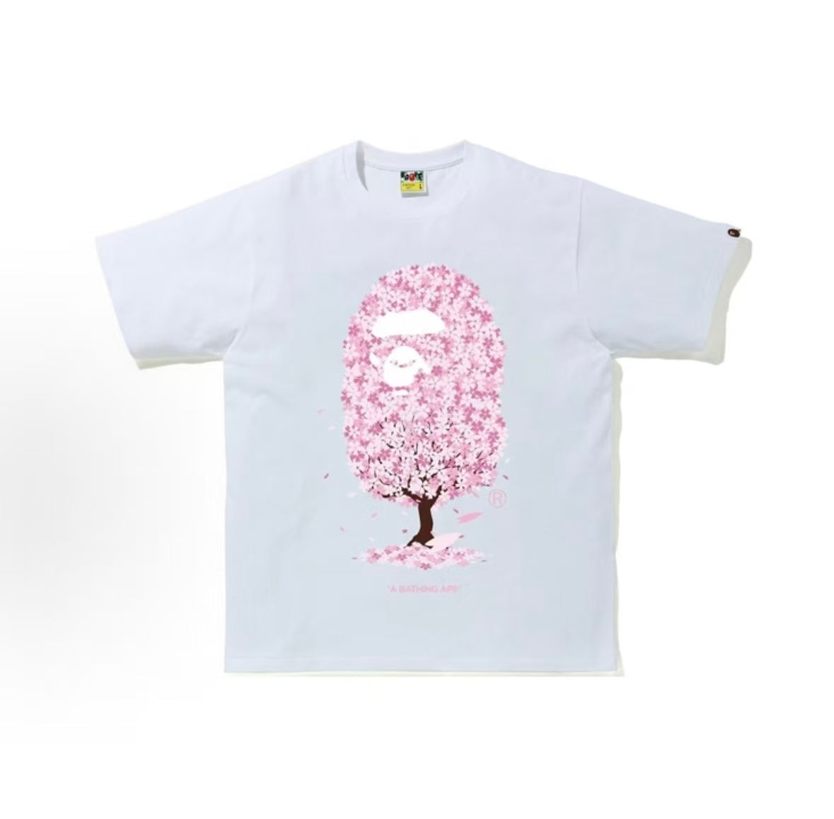 White BAPE Sakura Tree Ape Head Tee from THE EA STORE, featuring a graphic of an ape head with sakura flowers.