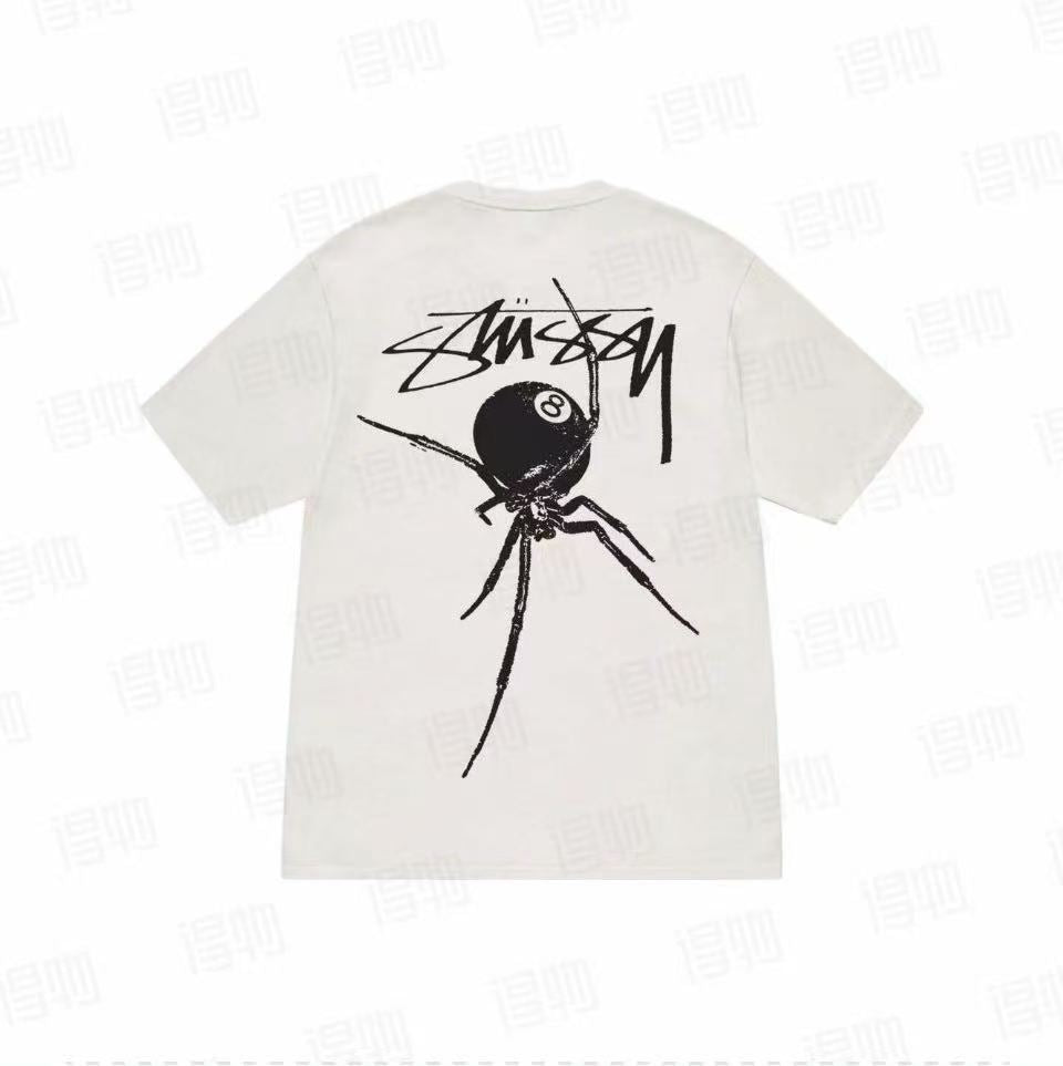Black Widow 8-Ball graphic T-shirt by Stüssy, featuring off-white and natural colors, casual essentials, displayed on a plain background.