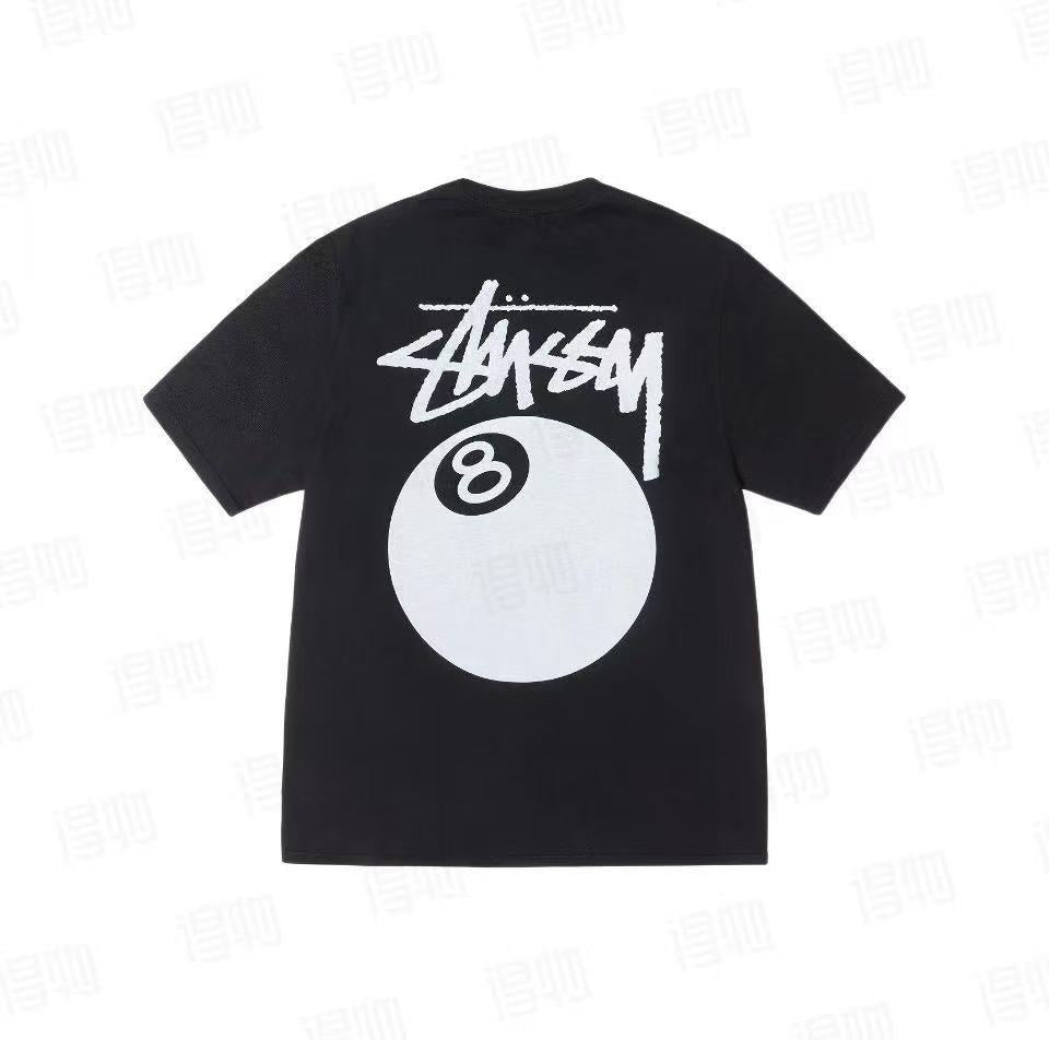 Black Stüssy Classic 8-Ball Graphic Tee from THE EA STORE, featuring bold 8-ball print on soft essentials t-shirt.
