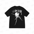 Black Stussy Spider 8 Ball T-shirt from THE EA STORE, featuring a graphic print on the front, casual essentials for streetwear style.