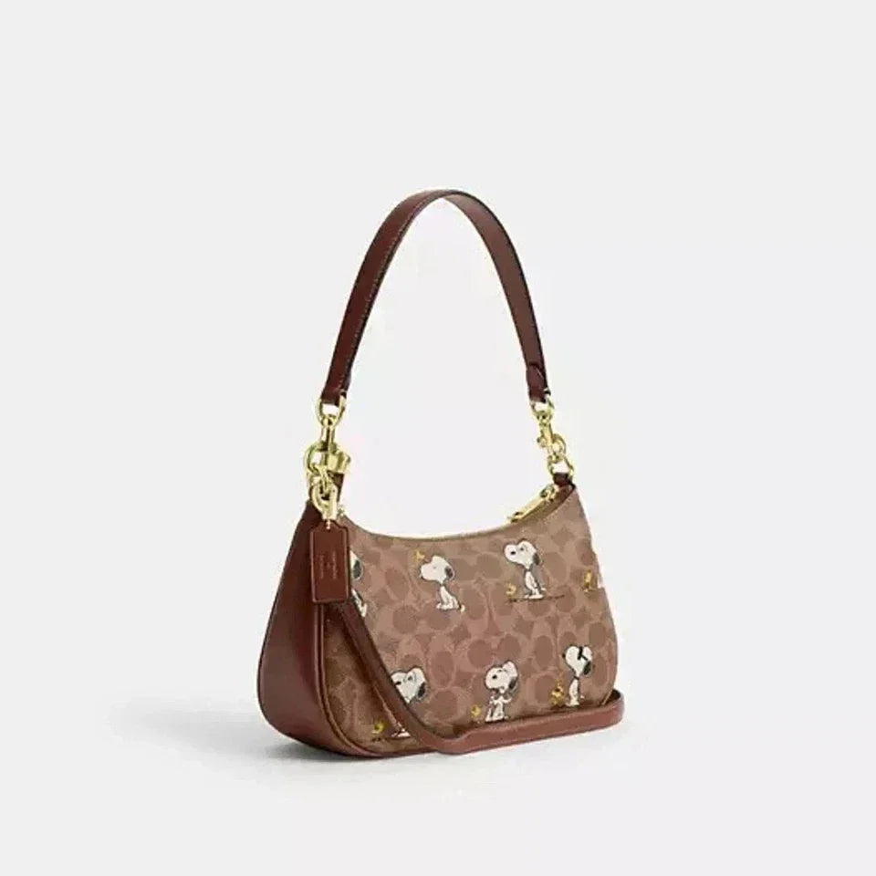 Coach Teri Shoulder Bag in signature canvas with gold, tan, and brown colors, featuring classic design and durable leather accents.