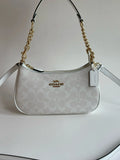 Coach Teri 2-Way Shoulder Bag in Signature coated canvas with white leather accents, stylish and versatile for everyday use.