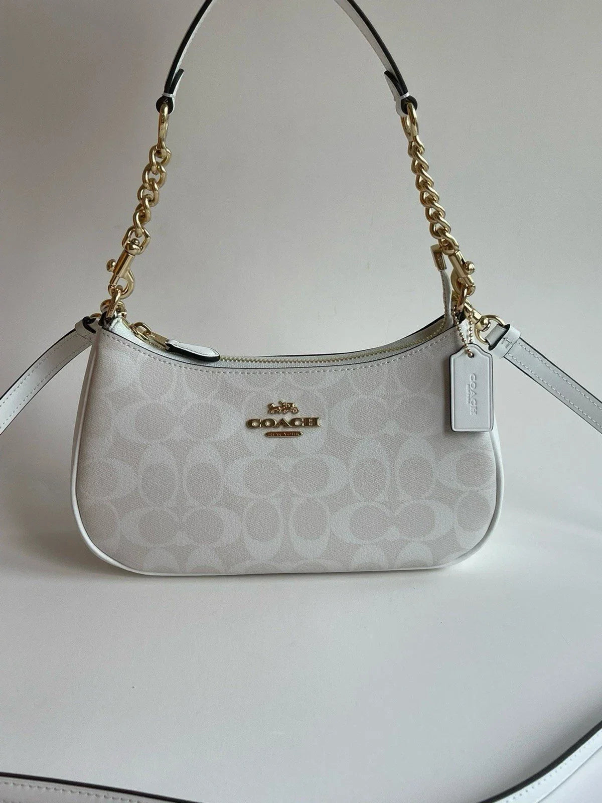 Coach Teri 2-Way Shoulder Bag in Signature coated canvas with white leather accents, stylish and versatile for everyday use.