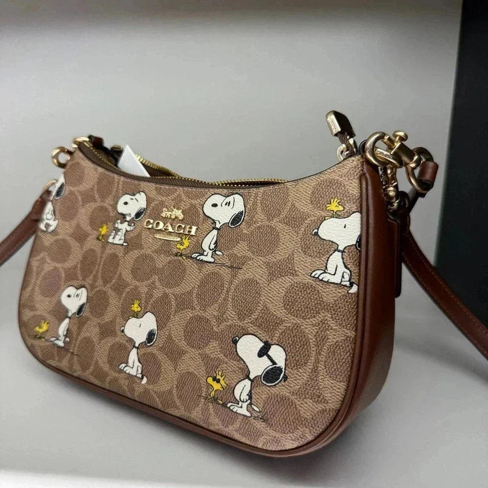 Coach Teri shoulder bag in signature canvas with gold, tan, and brown tones, featuring a stylish and spacious shoulder design.